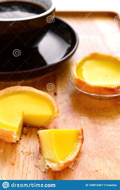 Fresh Egg Tarts With A Quarter Cut Out Andcup Of Coffee Stock Image