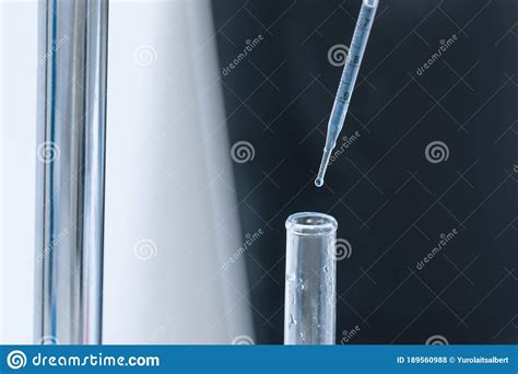 Close Up Scientist In A Glove Fills Test Tubes With A Pipette Stock
