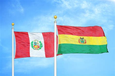 Peru And Bolivia Two Flags On Flagpoles And Blue Sky Stock Image