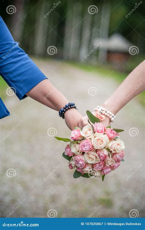 Couple Holds Hand With Wedding Flower Bouquet Stock Image Image Of