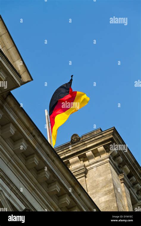 The German Flag Waving From The Reichstag In Berlin Germany Stock