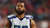 Seahawks' Michael Bennett sits during national anthem