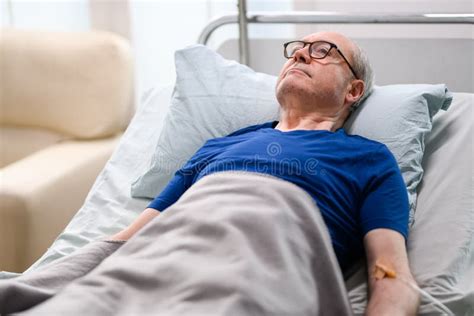 Thoughtful Old Man Laying Down On Bed Stock Photo Image Of Aged