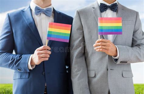 close up of male gay couple holding rainbow flags stock image image of love homosexuality