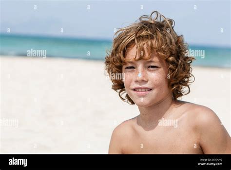 Spain Boy Sitting On Beach Smiling Stock Photo Alamy