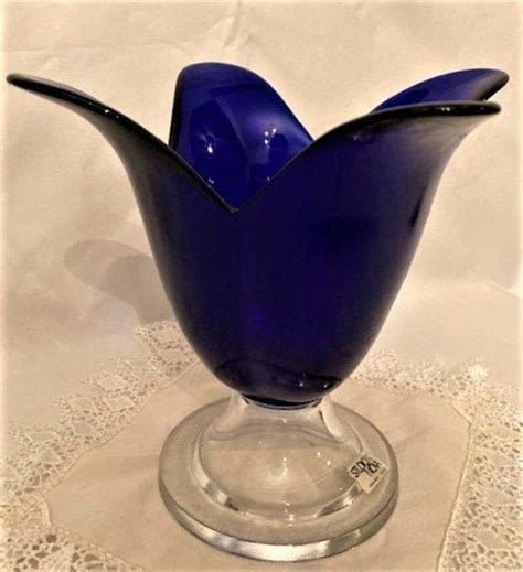 Inspired by a classic glass design, our handcrafted, clear glass direction hurricane candle holder is clean and simple, accented brilliantly with a single bubble formed in its substantial base. Vintage Studio Nova Cobalt Blue Glass Candle Holder Tulip ...