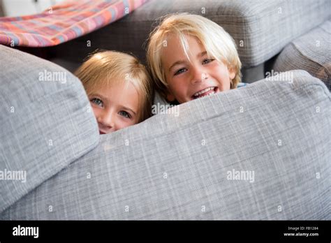 Boy 4 5 And Girl 6 7 Hiding Behind Pillows Stock Photo Alamy