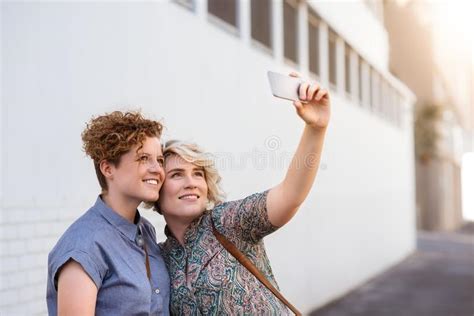 Laughing Lesbian Couple Having Fun Together At The Beach Stock Image