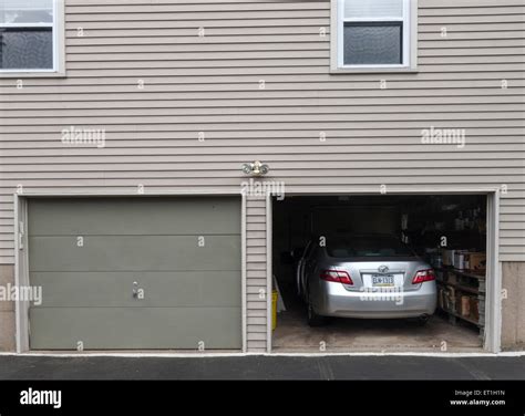 Open Garage Door With Car Parked Inside American Style Wooden House