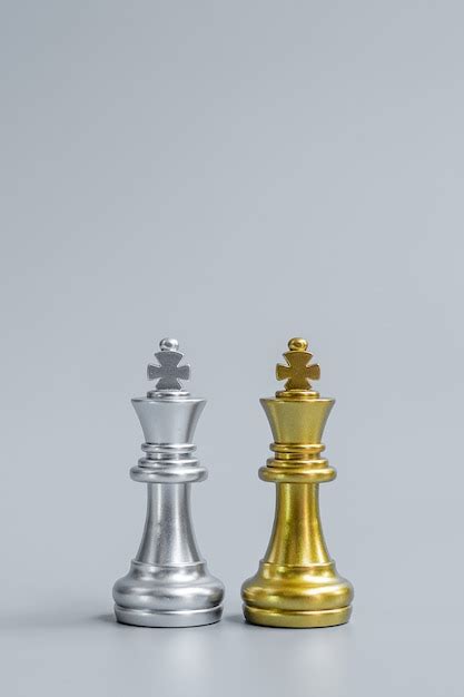 Premium Photo Gold And Silver Chess King Figure On Chessboard Against