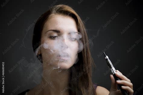 Elegant Woman Smoking E Cigarette With Smoke Stock 写真 Adobe Stock