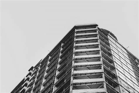 City Low Angle Grayscale Photography Of Concrete Building During