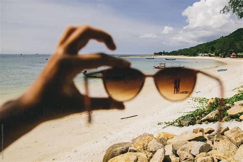 Hands Holding Sunglasses On A Beach By Stocksy Contributor Andrey