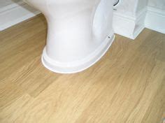When necessary, use a pull bar to tap the joints tight between the planks. How to Lay Laminate Flooring Around a Toilet in 2019 ...
