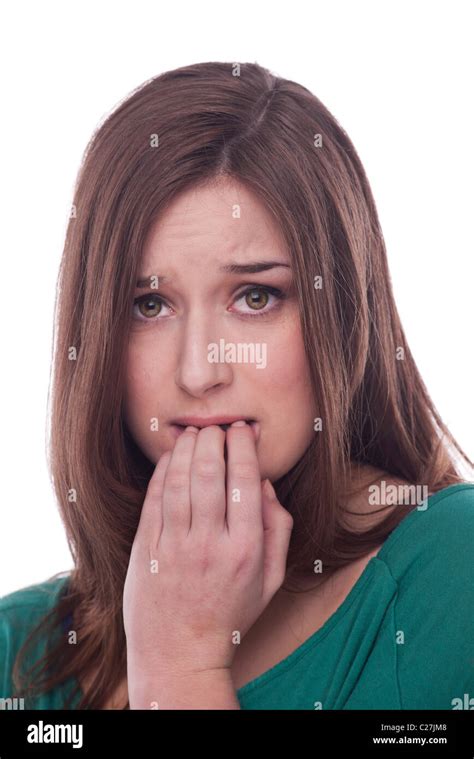 Brunette Woman Looking Worried And Biting Her Finger Nails With Nerves