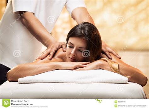 The Girl Relaxes In A Spa Salon And Gets Massage Stock