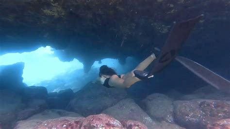 Female Diver Swimming Through Cave Youtube