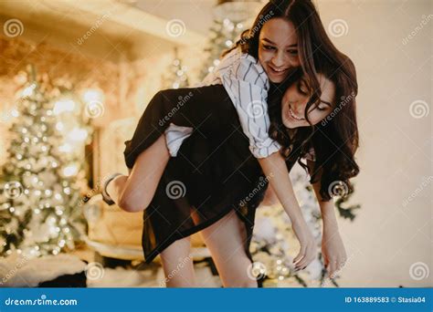 Lesbian Couple Has A Fun Against Background Of Christmas Decorations Stock Image Image Of