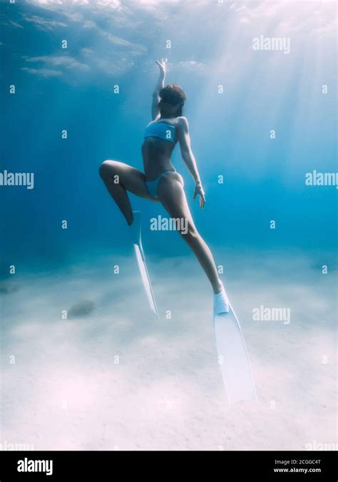 Freediver Glides Over Sandy Sea With White Fins Attractive Woman Free