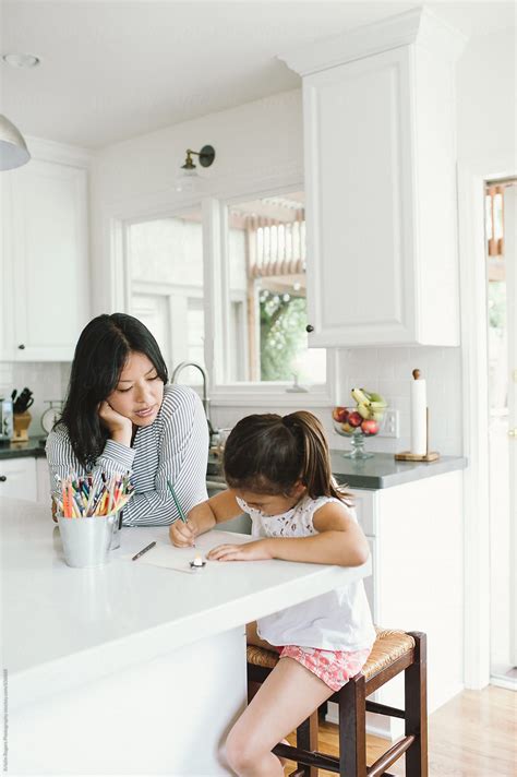 Mom Doing Homeschool Lesson In Kitchen With Daughter By Stocksy Contributor Kristin Rogers