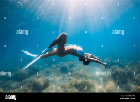 Freediver Glides Over Sandy Sea With White Fins Slim Woman Free Diver