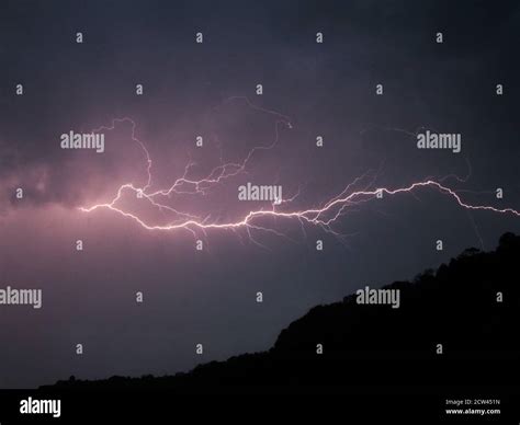 Horizontal Lightning Over A Hill Stock Photo Alamy