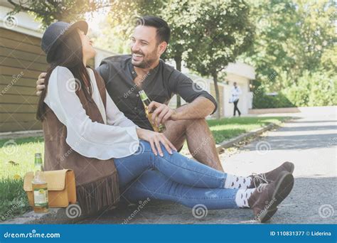 Young Couple Sitting In Park And Holding Bottle Of Drink Stock Image Image Of Mate Cheer