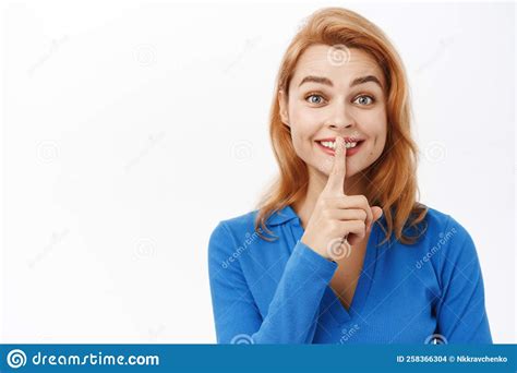 Close Up Portrait Of Excited Girl Say Shh Shush Taboo Sign Press Finger To Lips And Smiles