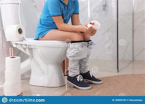 Boy Holding Toilet Paper With Blood Stain In Rest Room Hemorrhoid