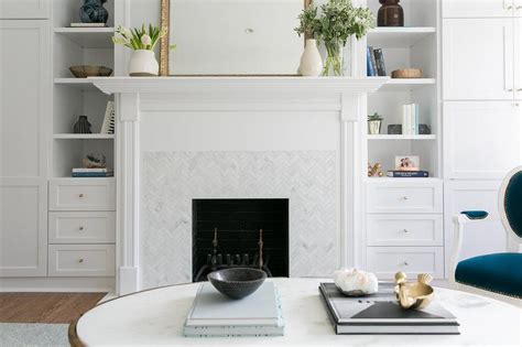 White Fireplace Mantel With White Marble Herringbone Tiles