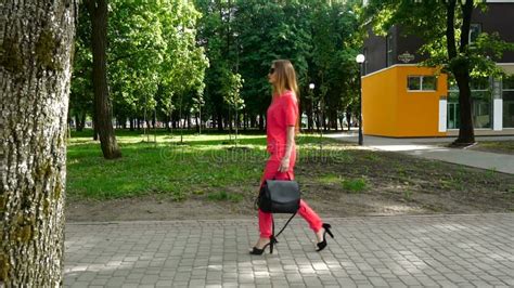 girl on high heels in a red suit with a bag walks stock video video of chic business 93637073