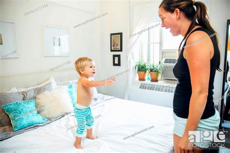 Mother And Son Talking In Bedroom Stock Photo Picture And Royalty