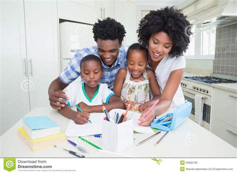 Happy Parents Helping Children With Homework Stock Photo