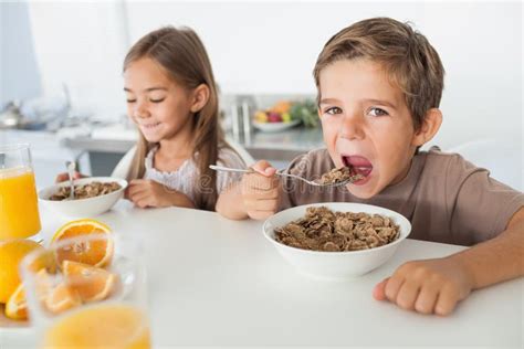 A Boy Is Eating Cereal From A Bowl Stock Photo Image Of Meal Snack