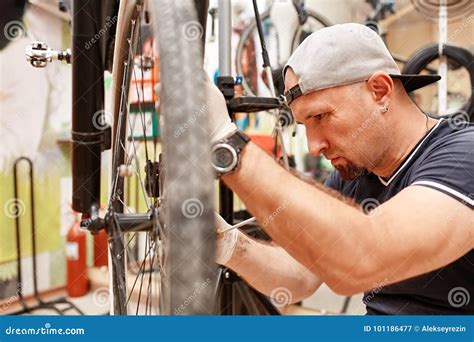 Bicycle Mechanic In A Workshop In The Repair Process Stock Image