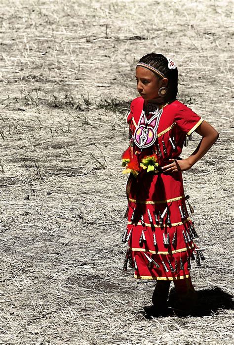 A Native American Girl In A Traditional Clothing During The Annual
