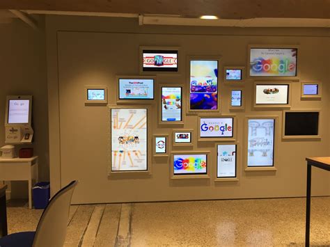 Welcome zone with pass maker and framed digital art (Doodles) at Google ...