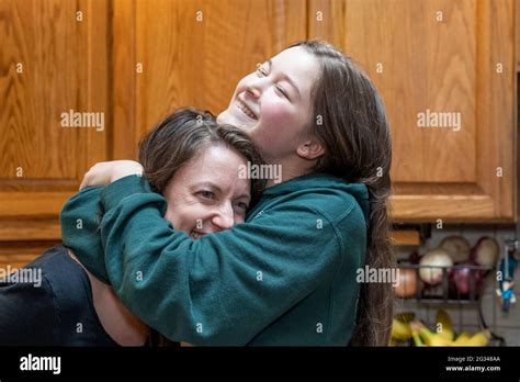 42 Year Old Mother And Her 15 Year Old Daughter Playfully Hugging With