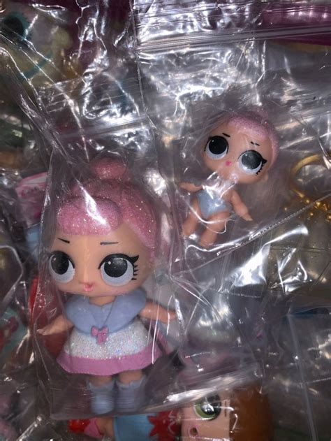Two Little Dolls Are In Plastic Bags On The Floor One Is Pink And The