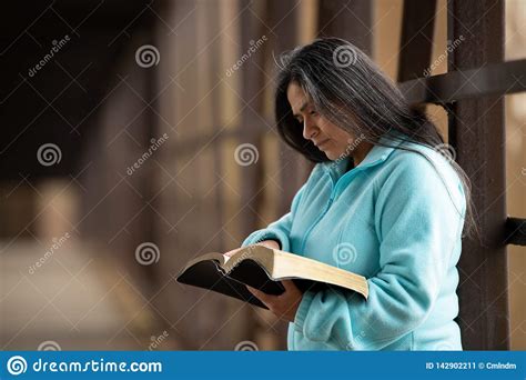 hispanic woman reading bible on bridge stock image image of scripture casual 142902211