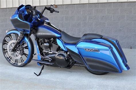 A Blue Motorcycle Parked In Front Of A Building