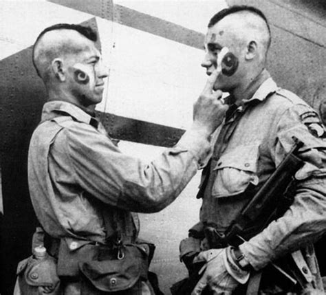 This Photo Shows A Soldier Applying Face Paint To His Fellow Buddy