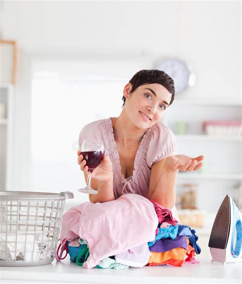 Smiling Woman With Wine And A Pile Of Clothes Stock Photo Image Of
