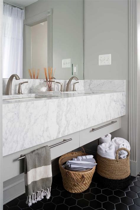 This herringbone marble floor from designer claire paquin really makes a statement in this sophisticated bathroom. Small Bathroom Decor Options