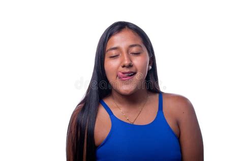 Black Woman With Mullet Hair Smiling And Sticking Out Her Tongue While Making A Sign Of Love