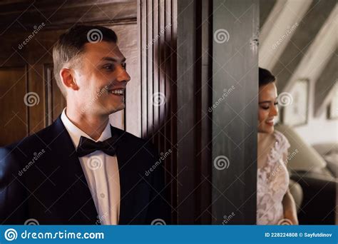 The Bride And Groom Talk Through The Wall At The Door Before The First