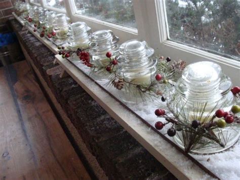 A Window Sill Filled With Lots Of Glass Jars And Candles On Top Of Snow