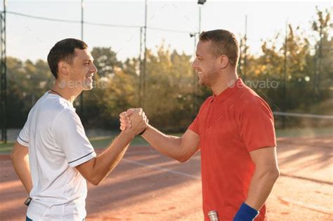 Two Friends Shaking Hands By Diignat Two Determined Men Are Shaking Hands Smiling Standing In