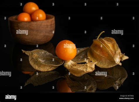 Group Of Five Whole One Piece Of Fresh Orange Physalis In Tiny Wooden