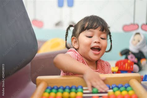 Cute Asian Little Kid Girl Playing With Abacus At Home Smart Child